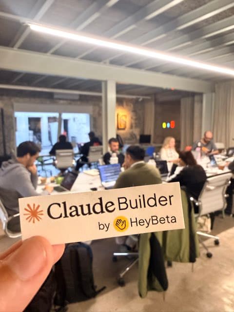 A Claude Builder by HeyBeta sticker in front of the workshop room.
